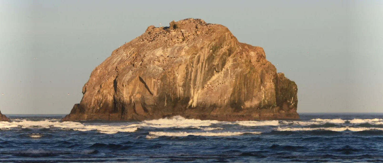 The Face Rock formation rising from the sea at golden hour