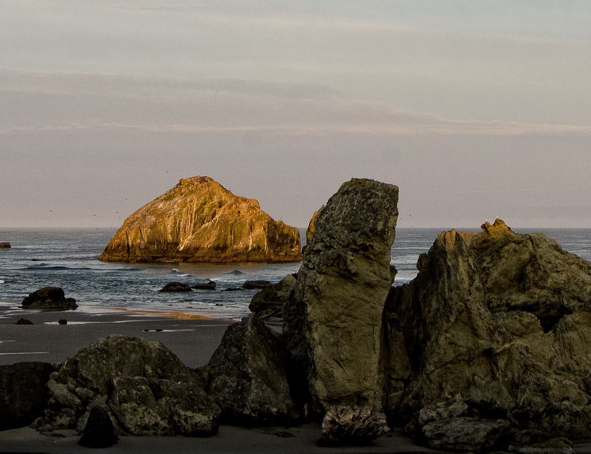 Face Rock at sunset with foreground rocks on the beach